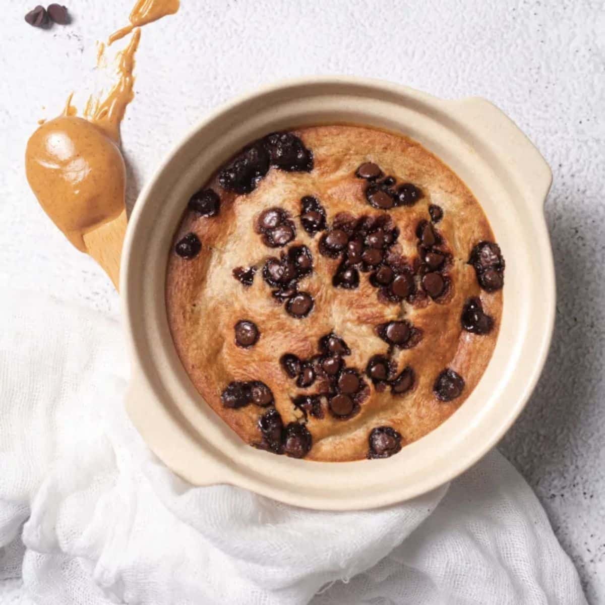 Bowl of baked oats topped with mini chocolate chips.