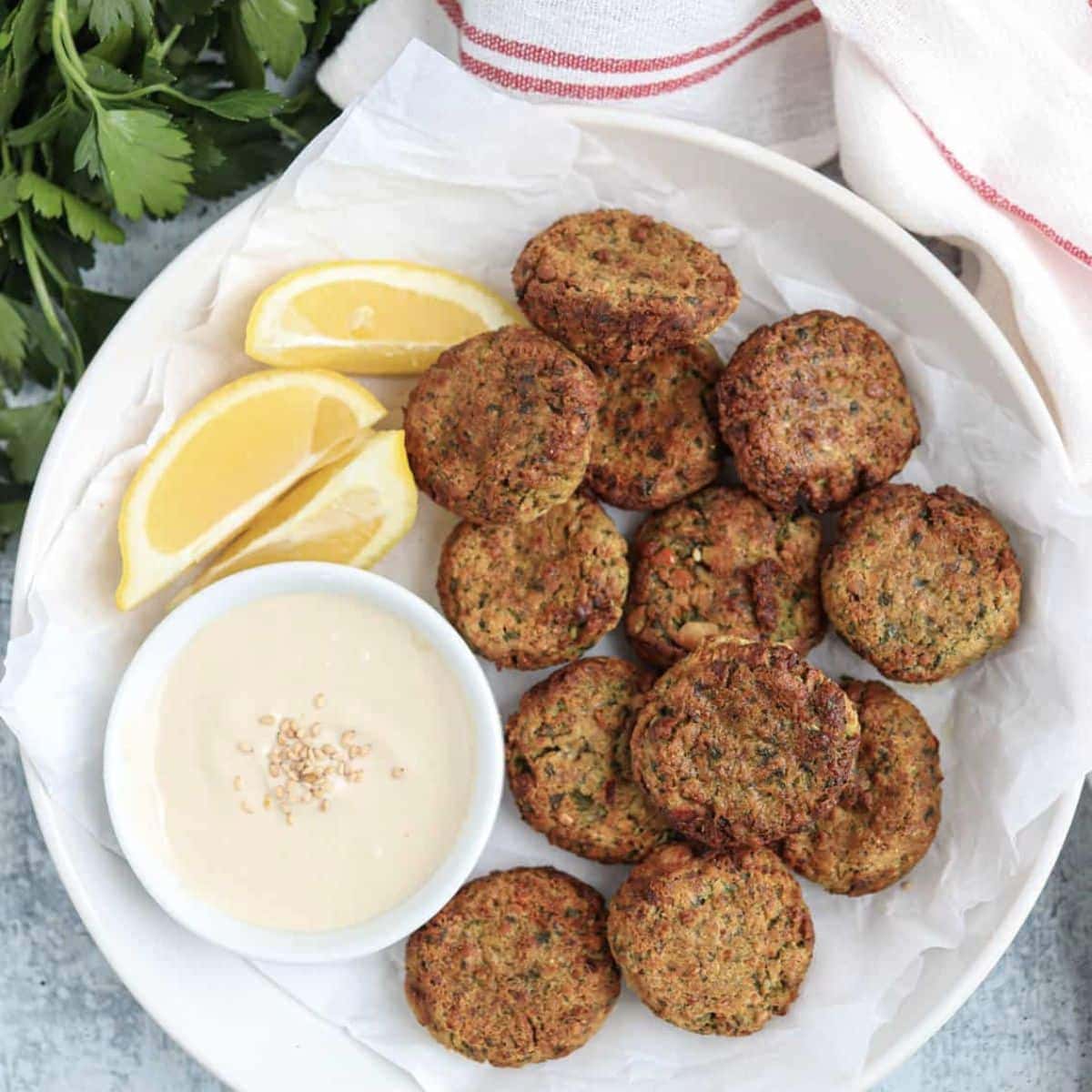Air fryer falafel on. aplate served witha side of tahini for dipping. 