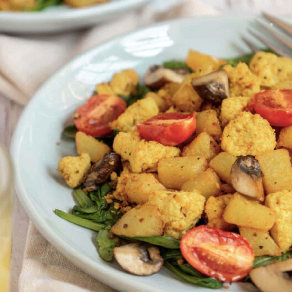 Tofu scramble with vegetables and home fries.