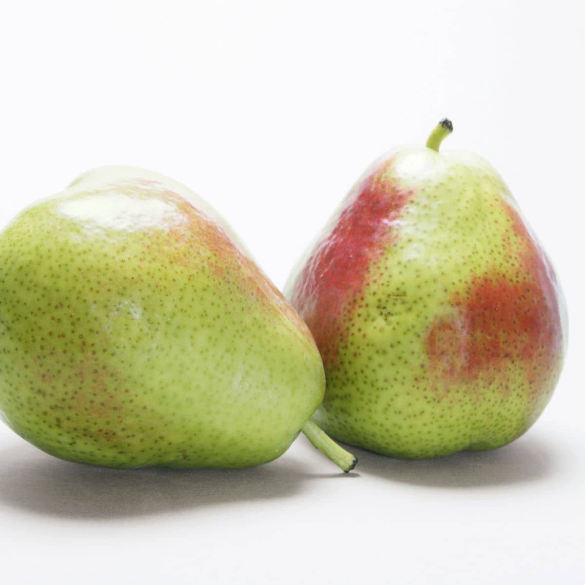 Queen forelle pears with a green skin and a slight red hue.