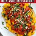 Baked polenta dish with roasted vegetables and lentils.