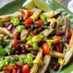 Vegan cheese fries topped with vegetables and beans.