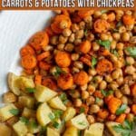 Roasted carrots, potatoes and chickpeas topped with fresh herbs on a serving platter.