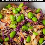 Asian cabbage salad in a bowl topped with edamame.
