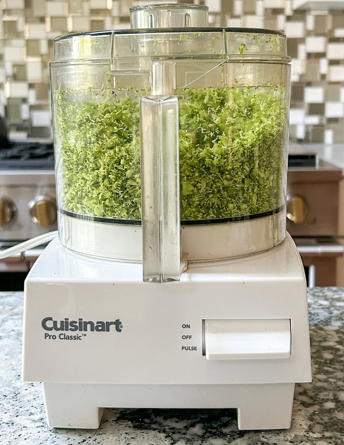 Broccoli pieces in food processor.
