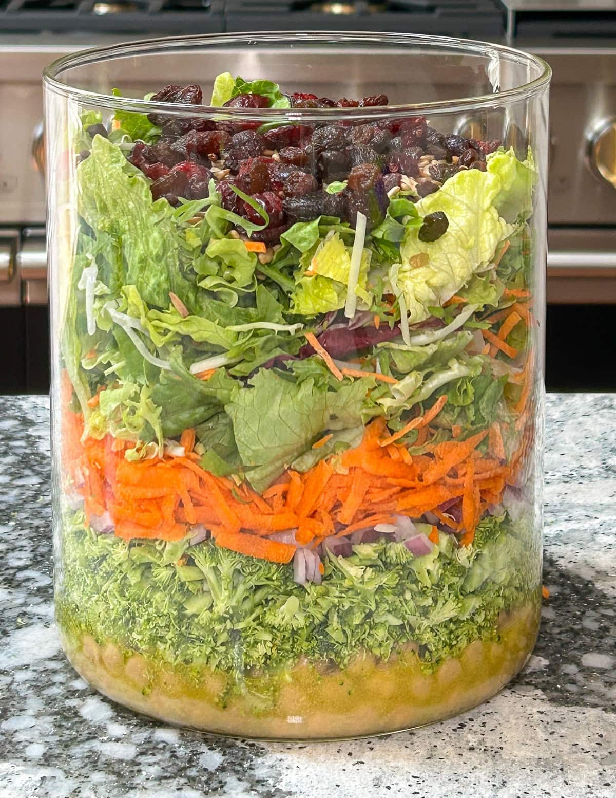 Broccoli salad layered in a large jar.