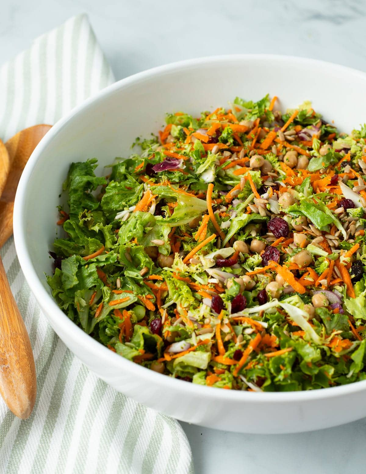 Broccoli crunch salad in a large white serving bowl.