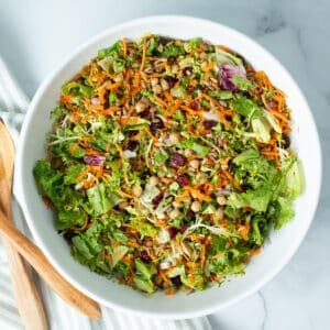 Broccoli crunch salad in a large white serving bowl.