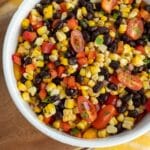 Charred corn salad in a white serving bowl.