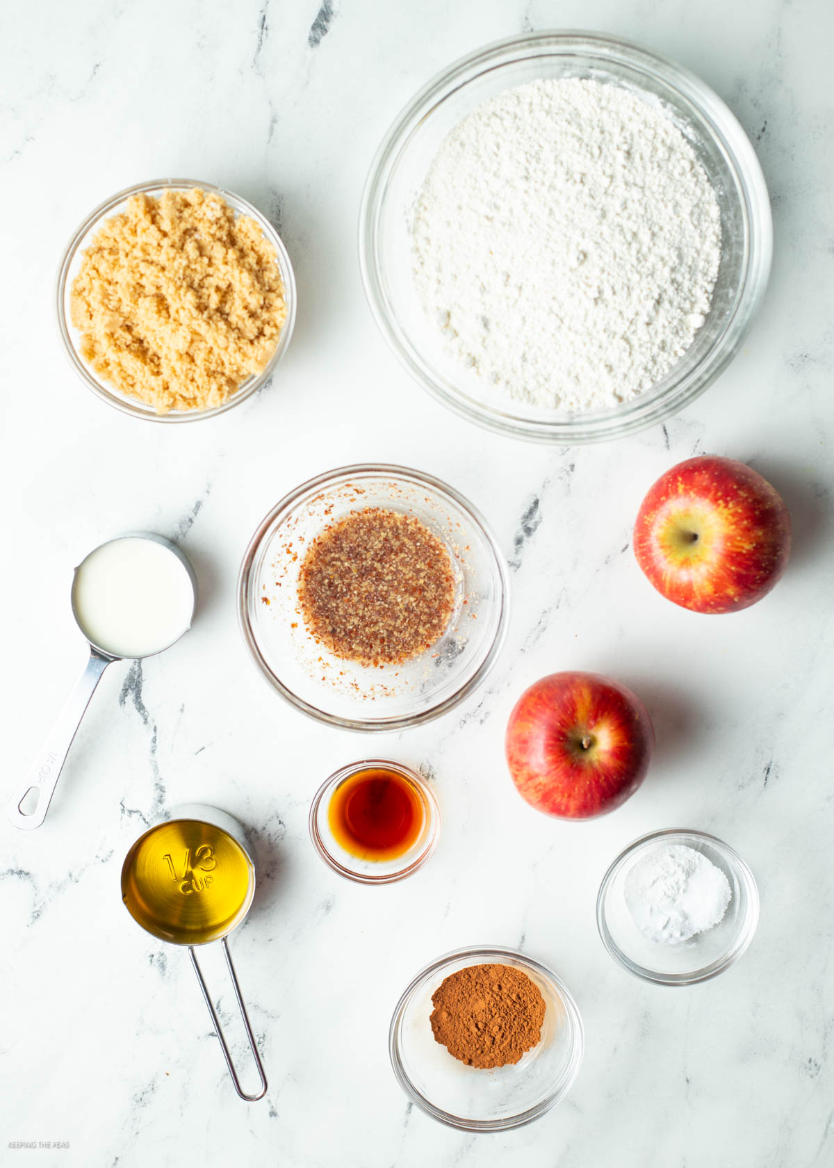 Vegan apple cinnamon muffin ingredients in small bowls.