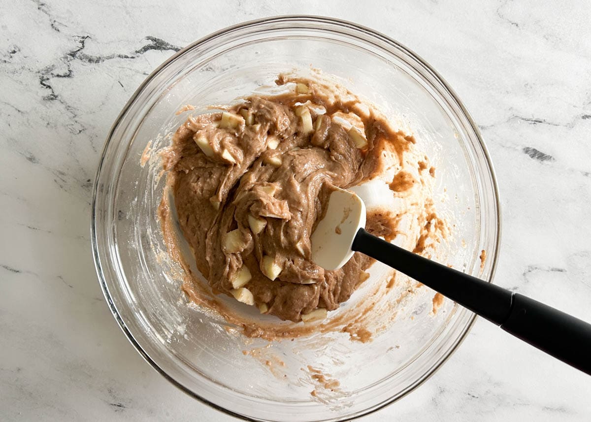 Apple muffin batter in glass bowl.