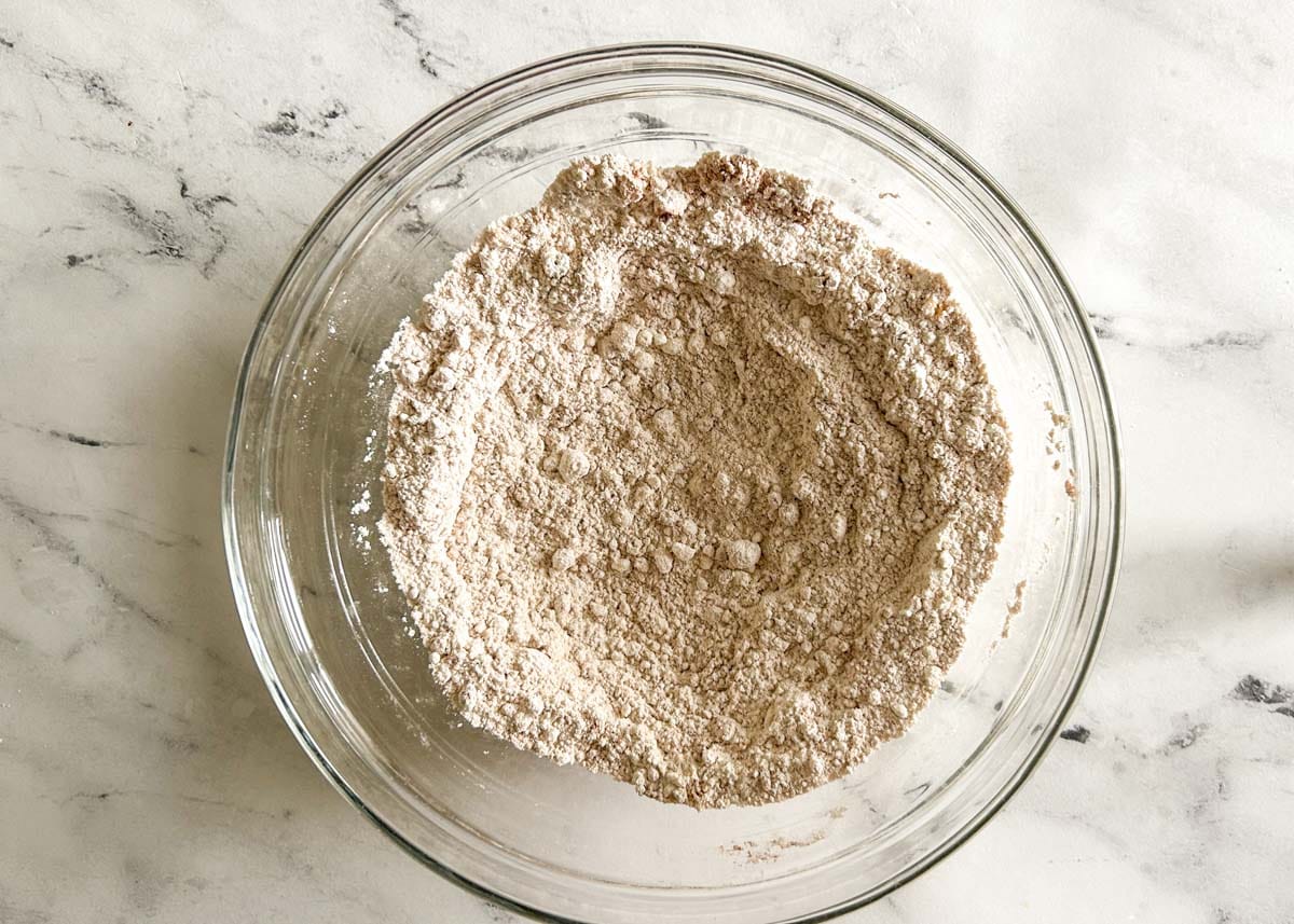 Dry ingredients whisked together in a glass bowl.