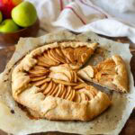 Vegan apple galette on parchment paper.