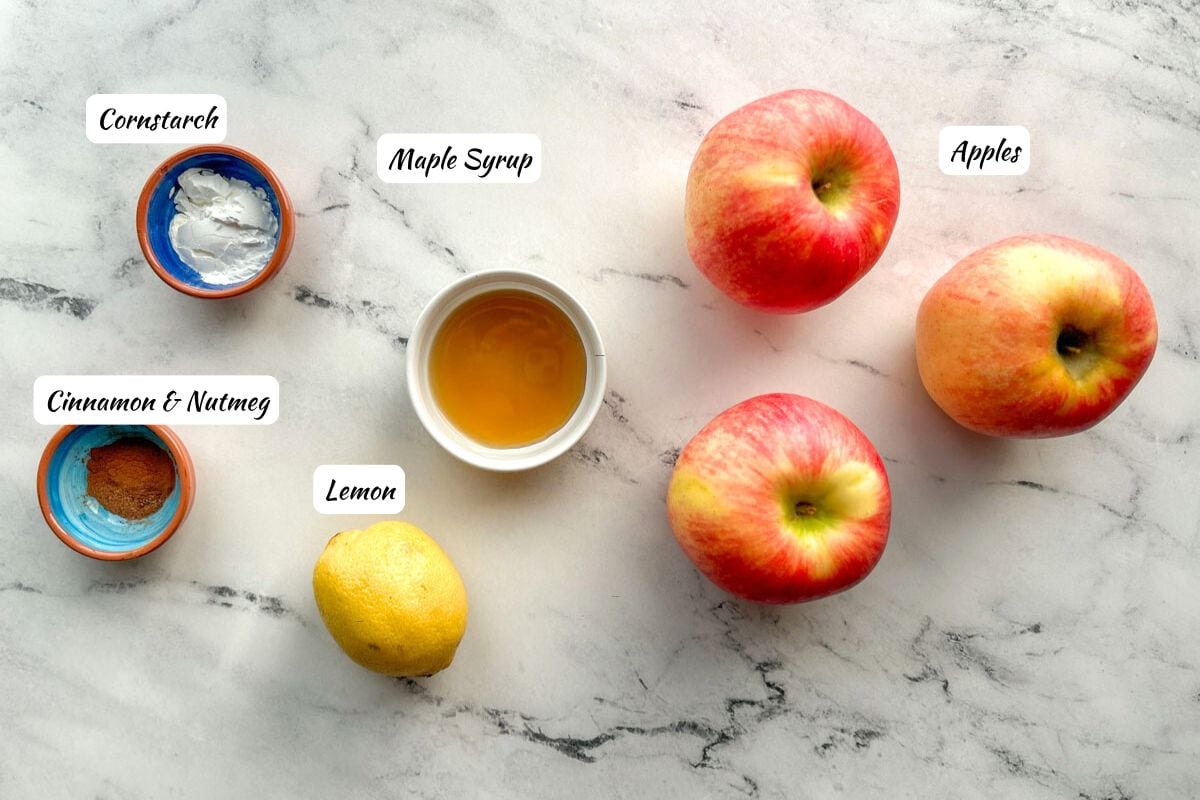 Apple filling ingredients: cornstarch, cinnamon and nutmeg, lemon, maple syrup, apples.