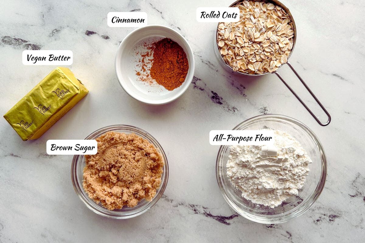 Vegan streusel ingredients: vegan butter, brown sugar, cinnamon, rolled oats, all-purpose flour.