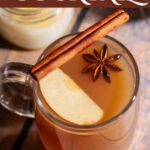 Hot apple cider cocktail in a glass mug.