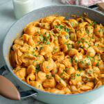 Pasta shells coated in hidden veggie pasta sauce in pot.