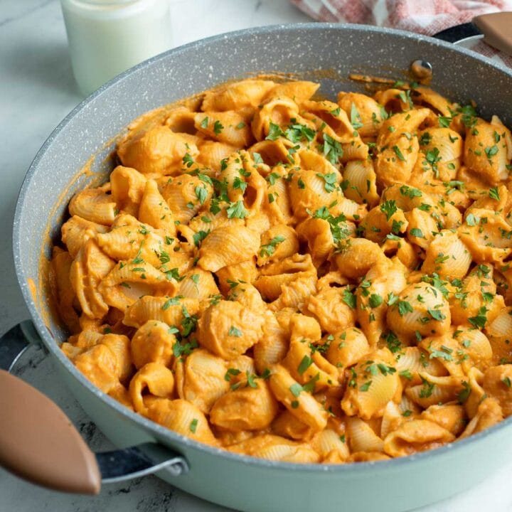 Pasta shells coated in hidden veggie pasta sauce in pot.