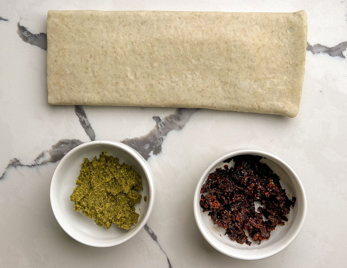 Savory Palmiers Ingredients: puff pastry, pesto, sun-dried tomato paste.