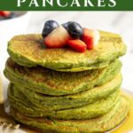 Stack of spinach banana pancakes served with a side of berries.
