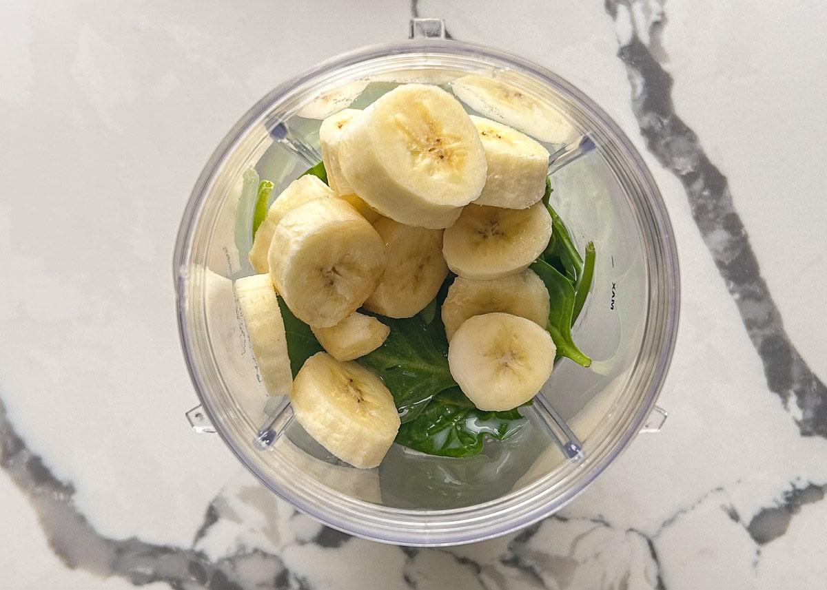Spinach and banana in a blender.